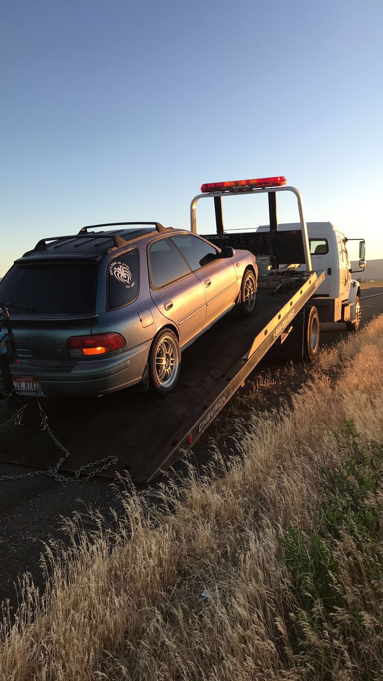 A car is being towed by a tow truck.