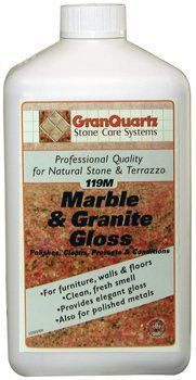 A bottle of marble and granite gloss is sitting on a table. A bottle of marble and granite gloss for natural stone and terrazzo.