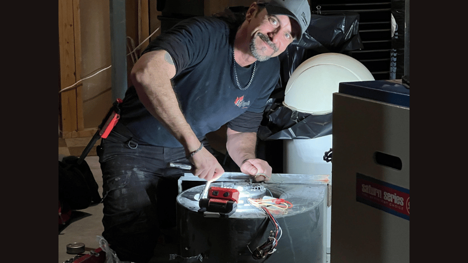 A man is using a circular saw to cut a pipe.