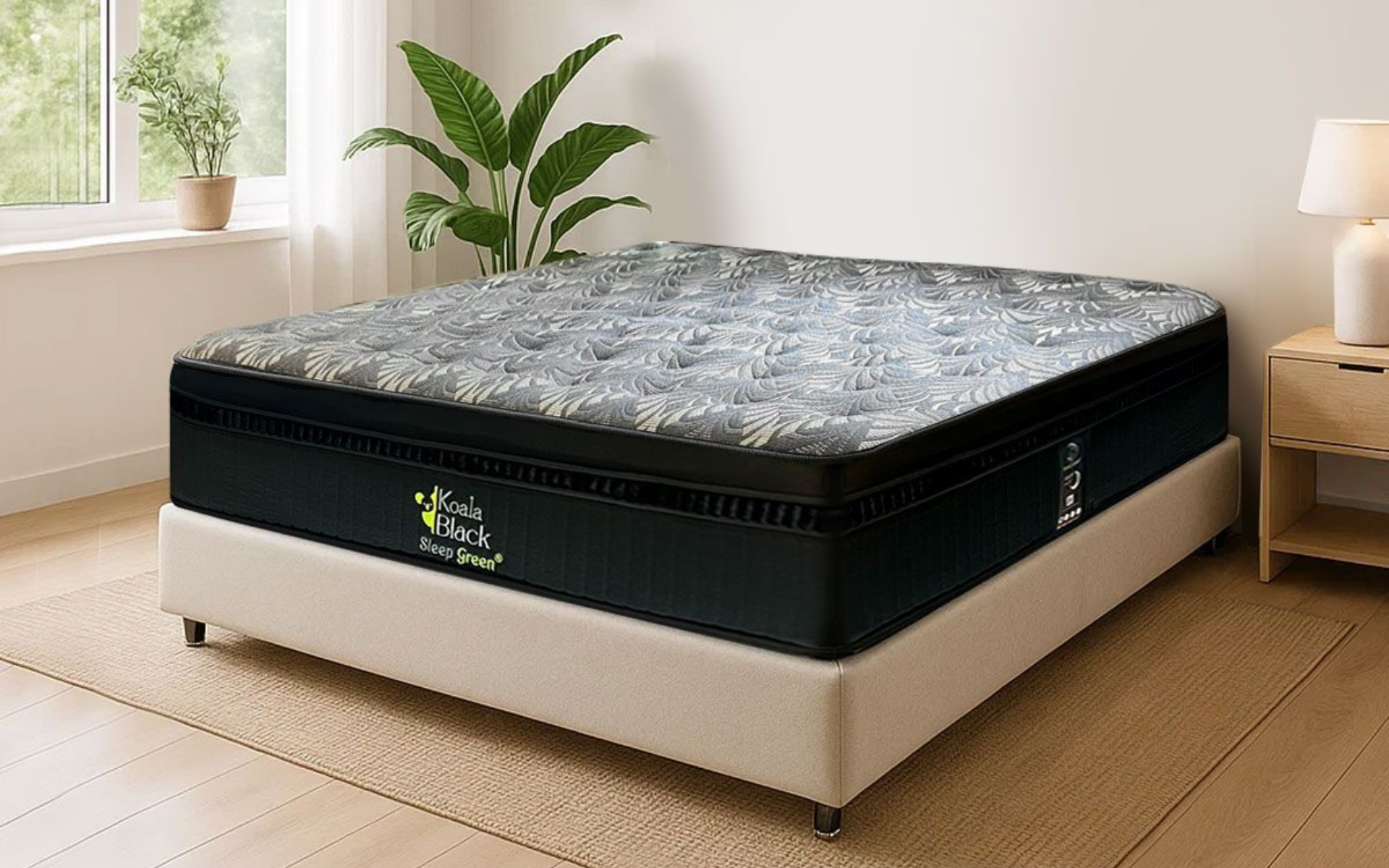 Colchón negro y gris sobre un marco de cama beige en un dormitorio bien iluminado con plantas y una lámpara.