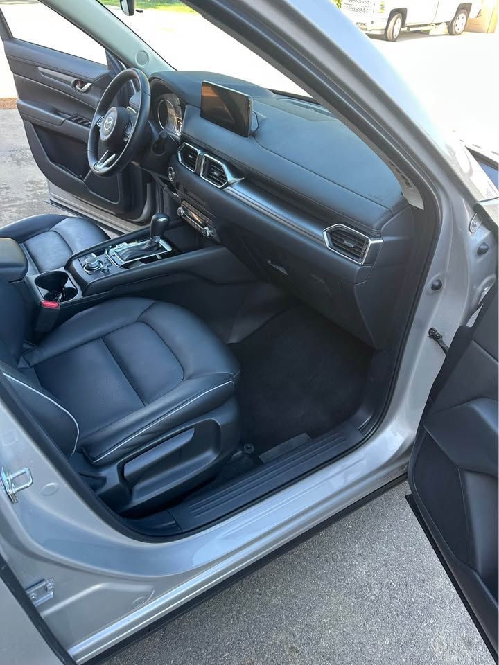 The interior of a silver car with the door open