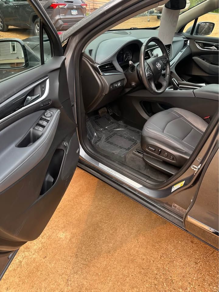The interior of a car is shown with the door open.