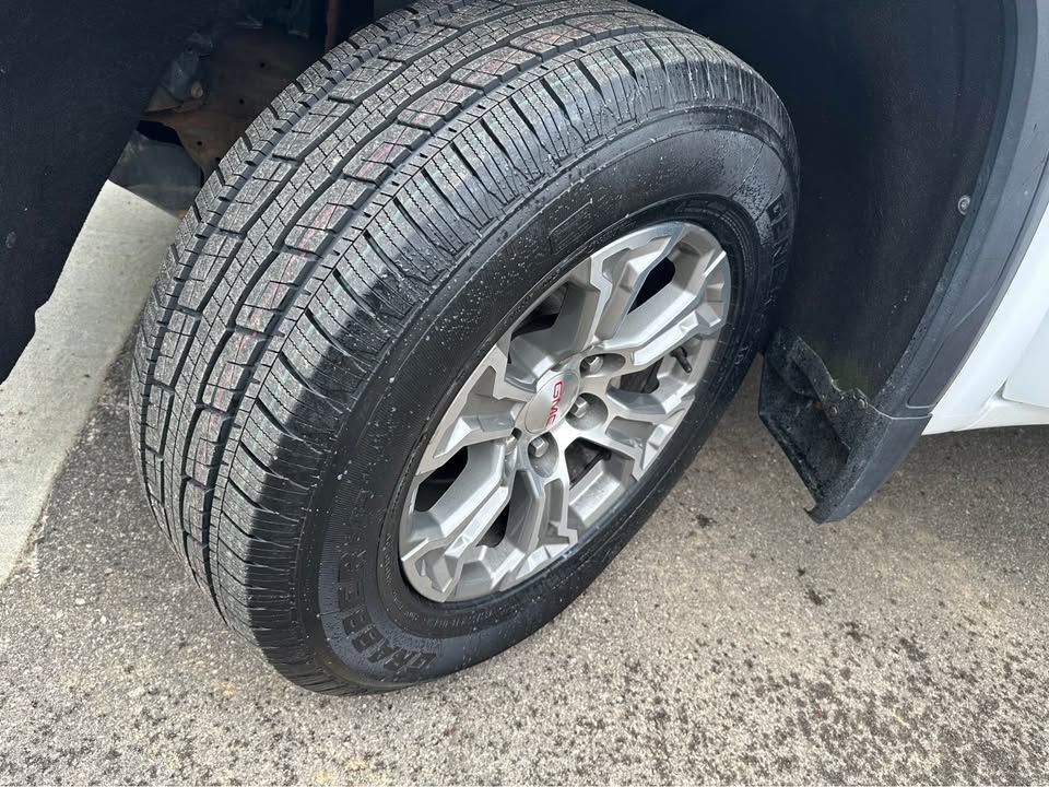 A close up of a tire on a white truck.