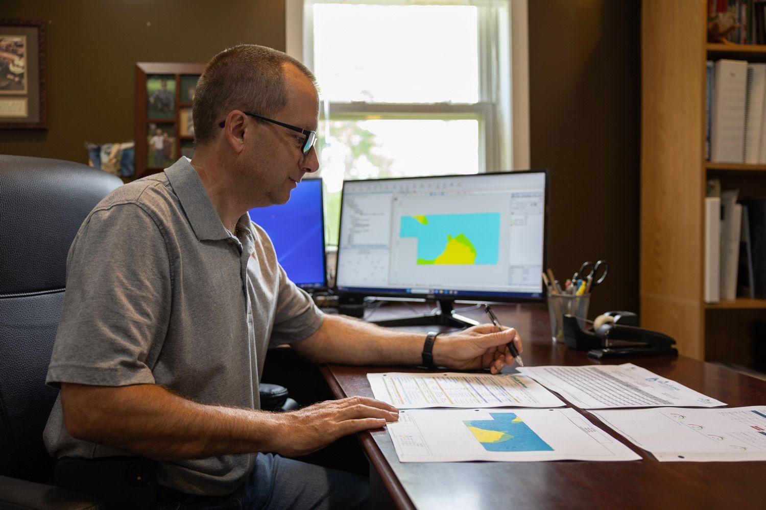 A man is sitting at a desk in front of a computer.