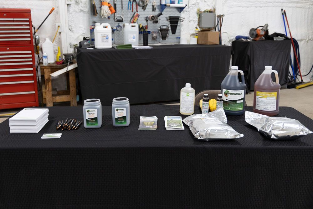 A table with bottles and bags of humid materials on it