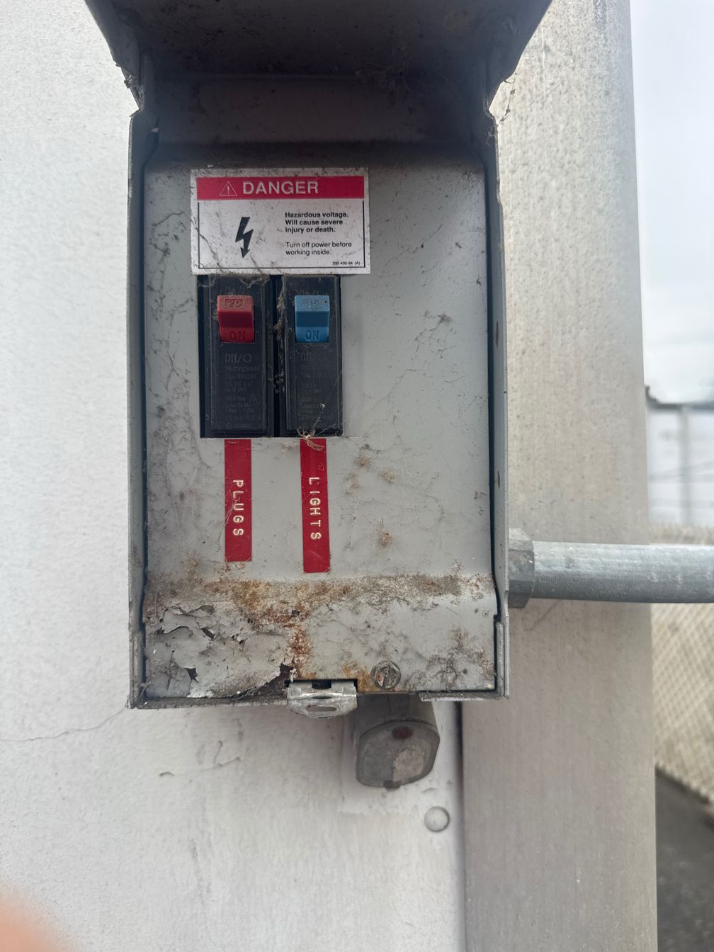 Electrical box with red and blue circuit breakers labeled 
