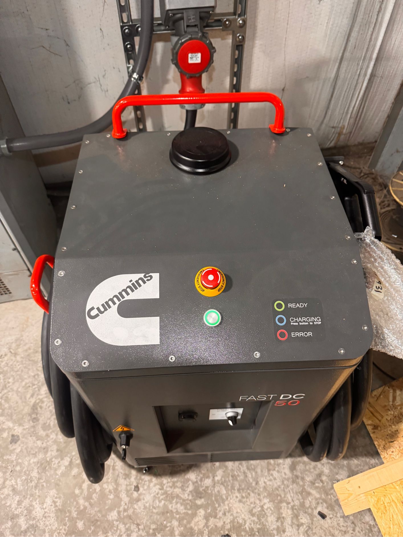 Gray Cummins power unit with red handle, buttons, and wheels.