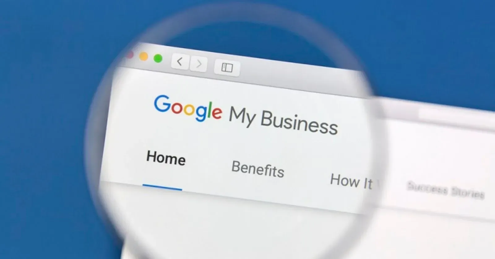 Google My Business website on a computer screen, viewed through a magnifying glass.