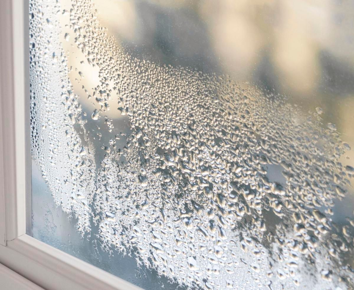 Steamy window with condensation, droplets visible on glass.