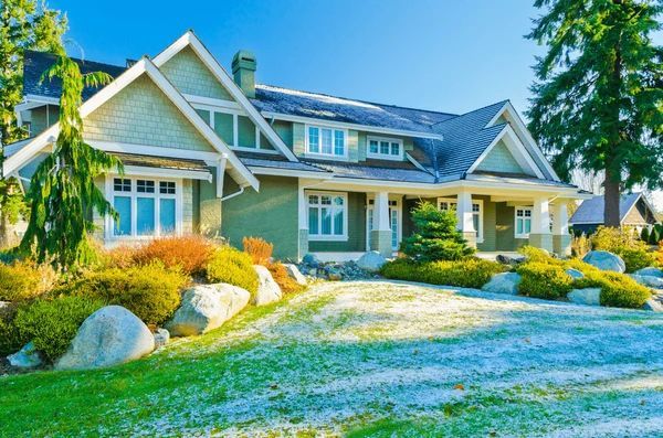 A large house with a large driveway in front of it.