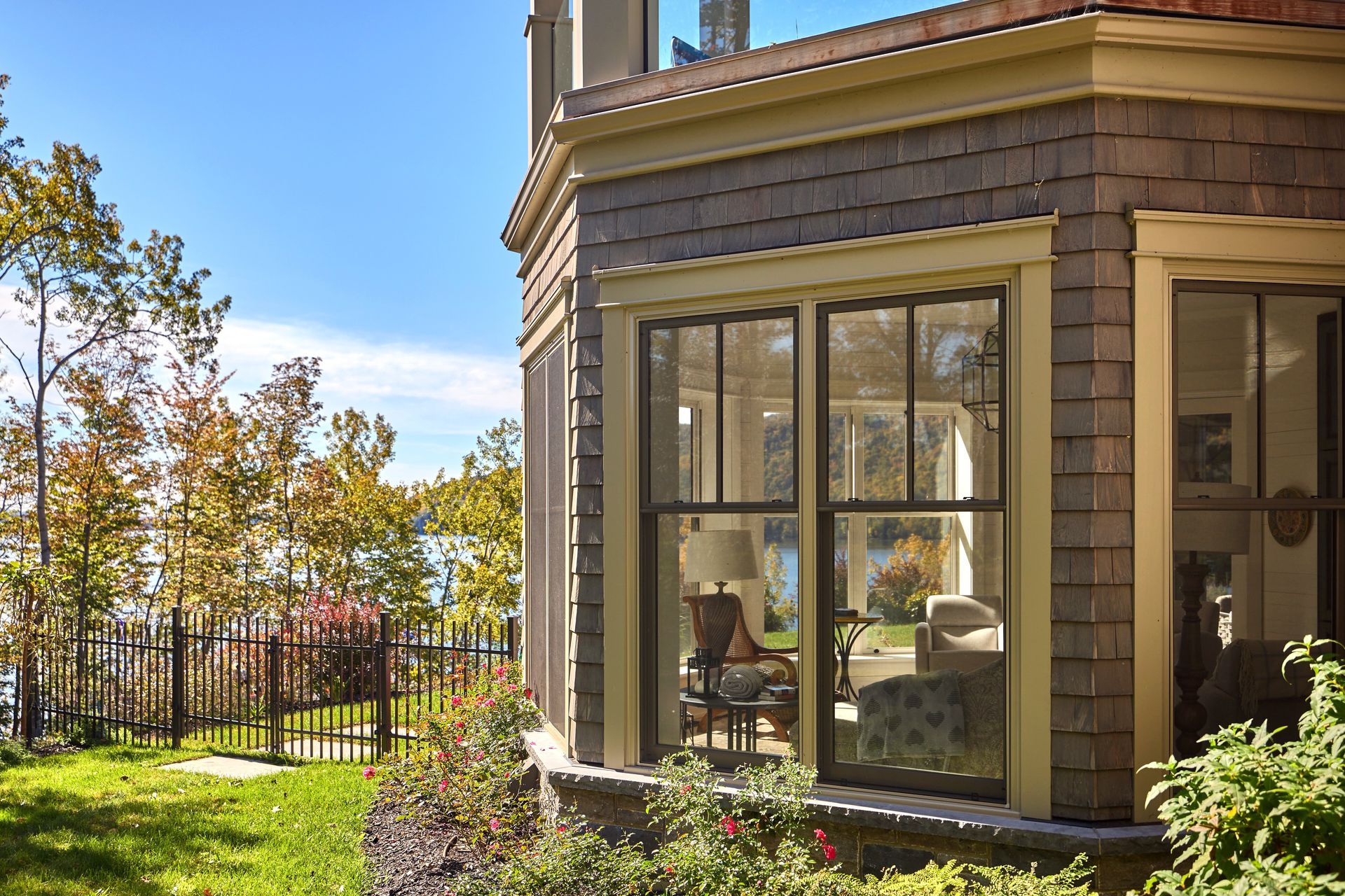 A house with a lot of windows and a fence