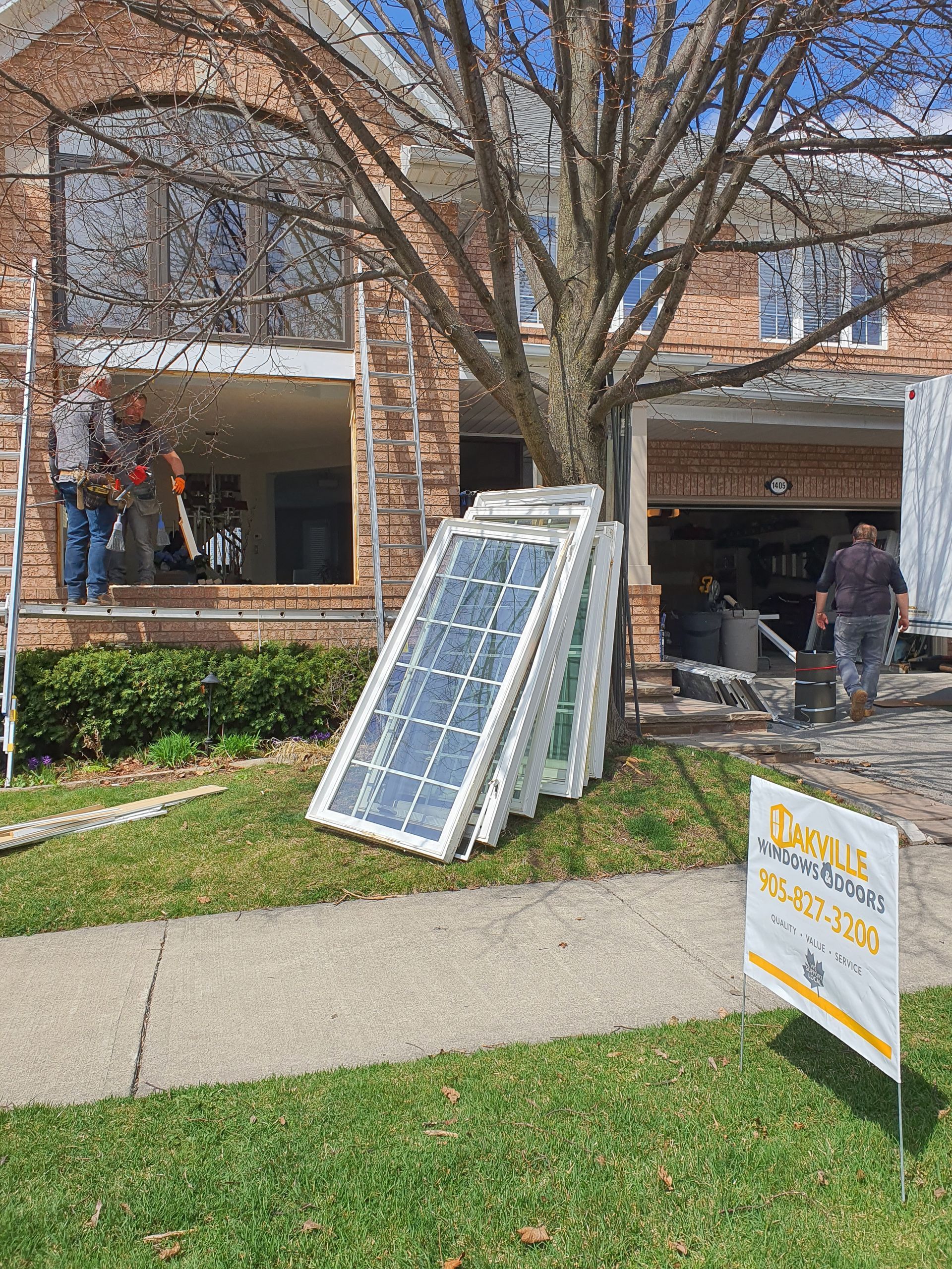 A house is being remodeled with a sign in front of it.