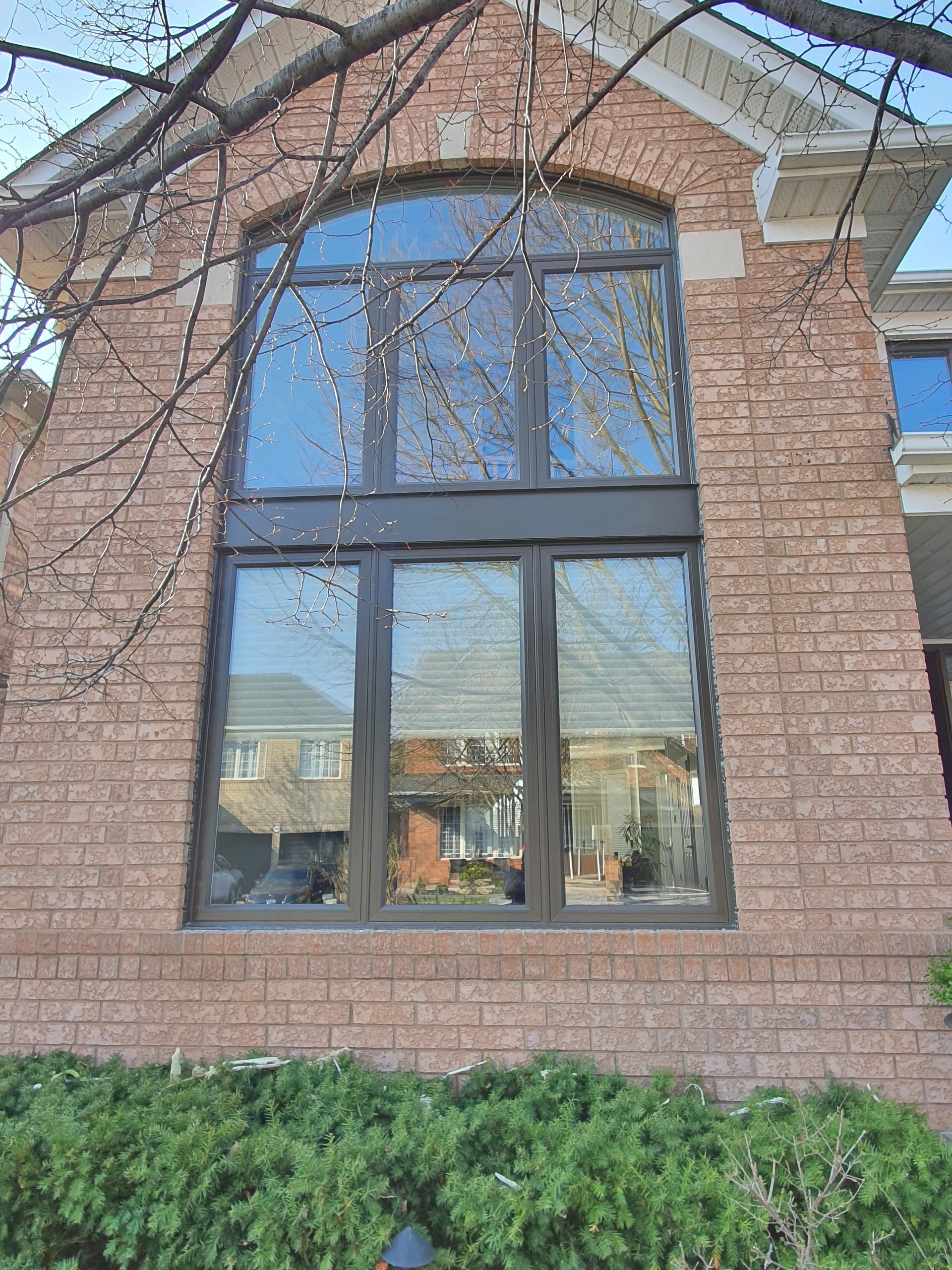 A large window on the side of a brick building