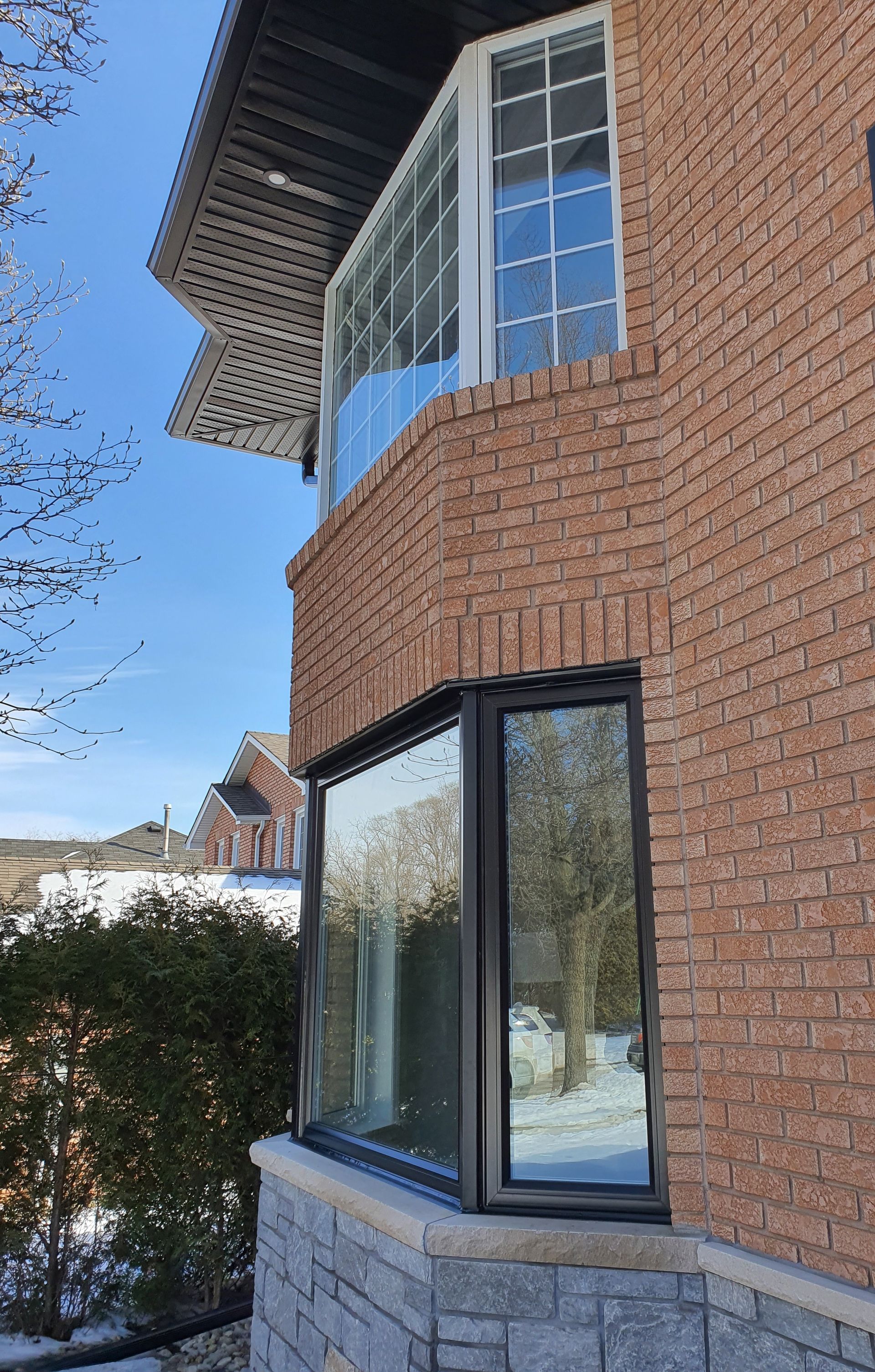 A brick building with a large window on the side of it.
