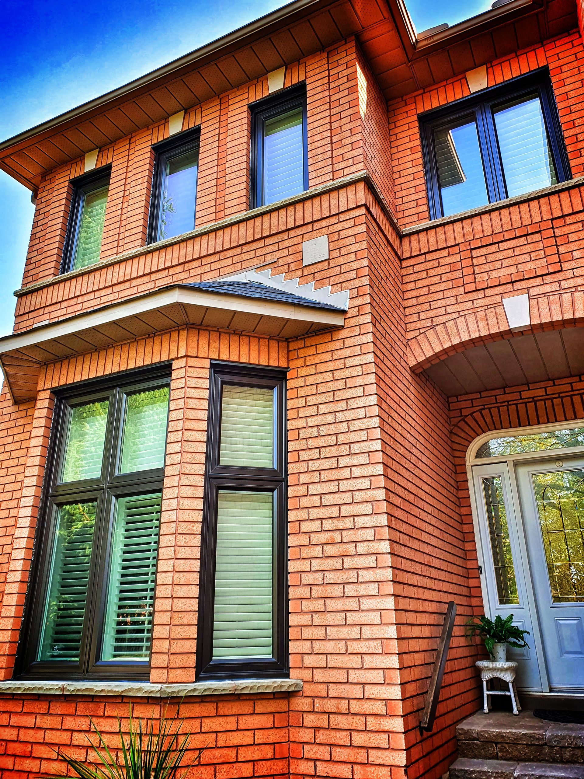 A large brick house with a lot of windows and stairs.