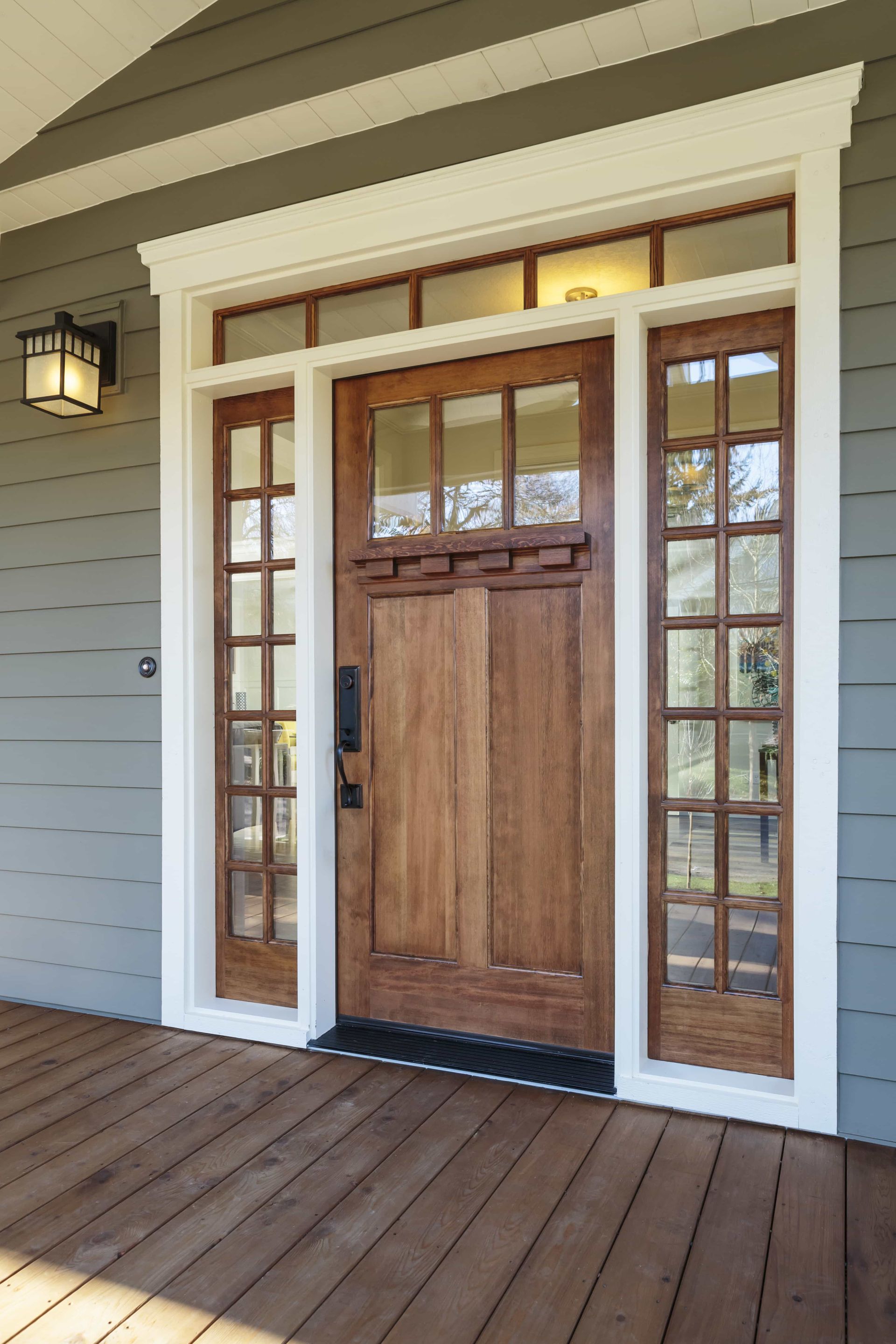 The front door of a house with a wooden porch