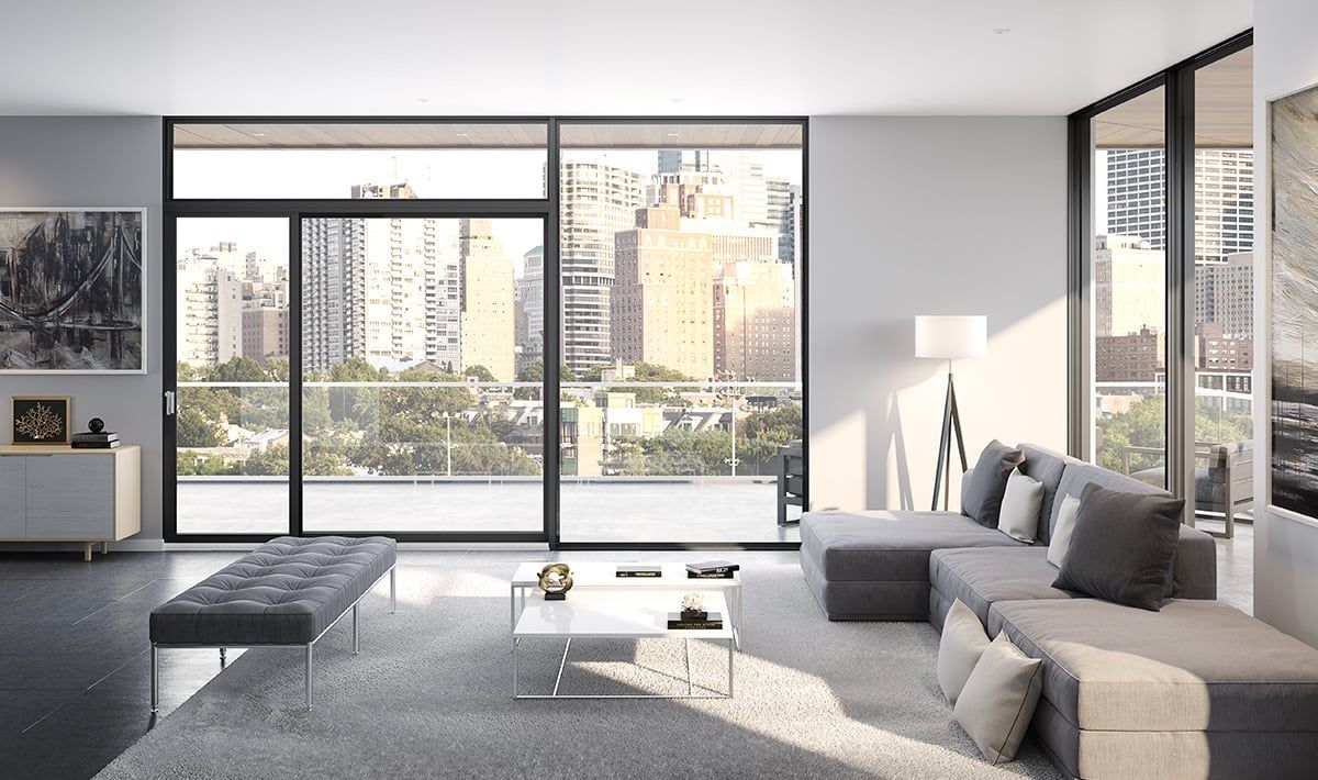 A living room with a lot of windows and a couch