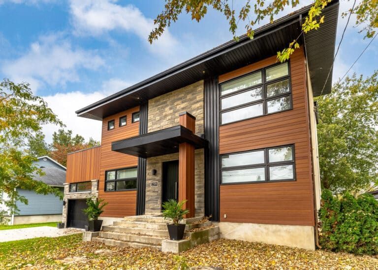 A large house with a lot of windows and stairs in front of it.