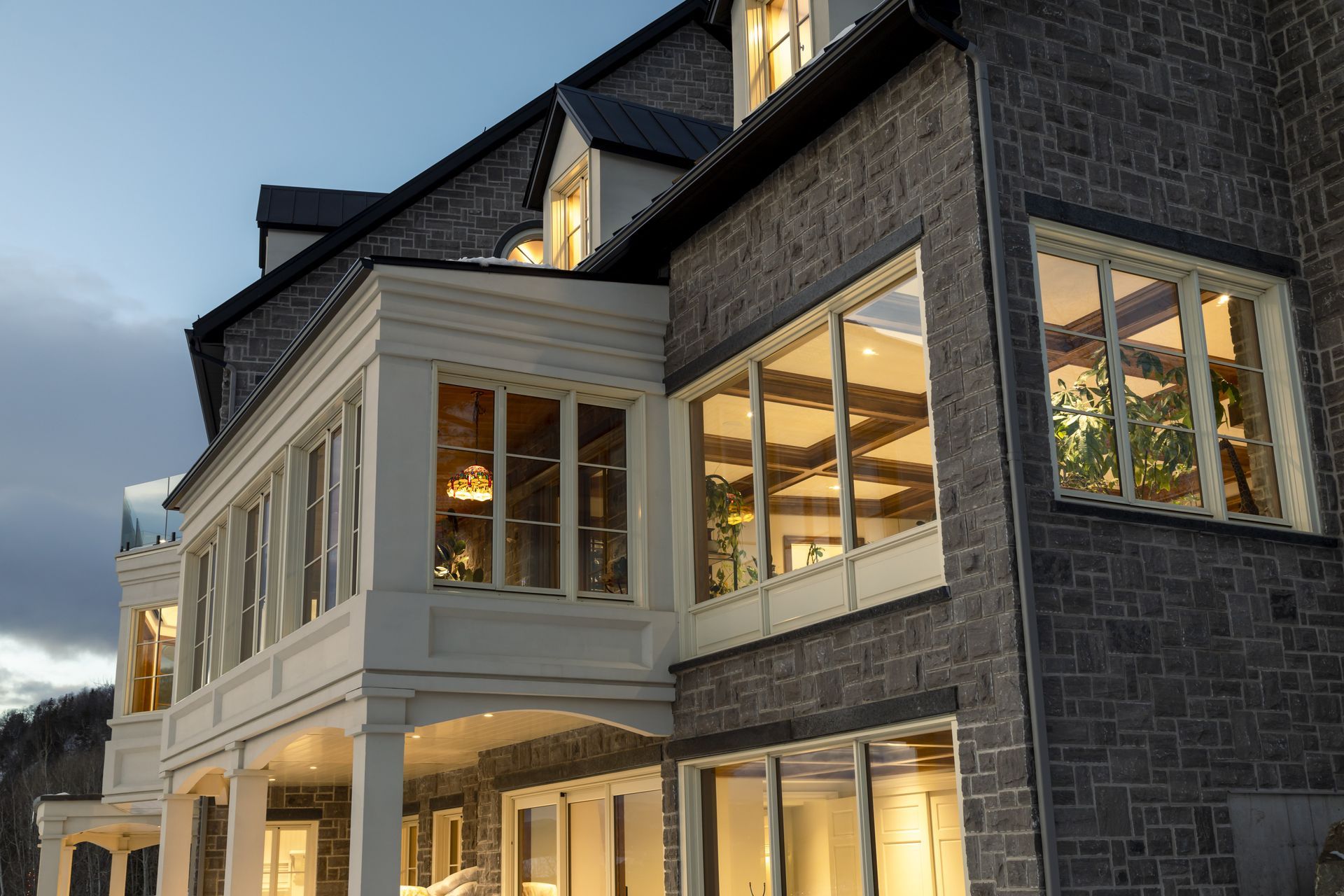 A large brick building with a lot of windows is lit up at night.