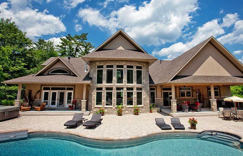 a large house with a swimming pool in front of it