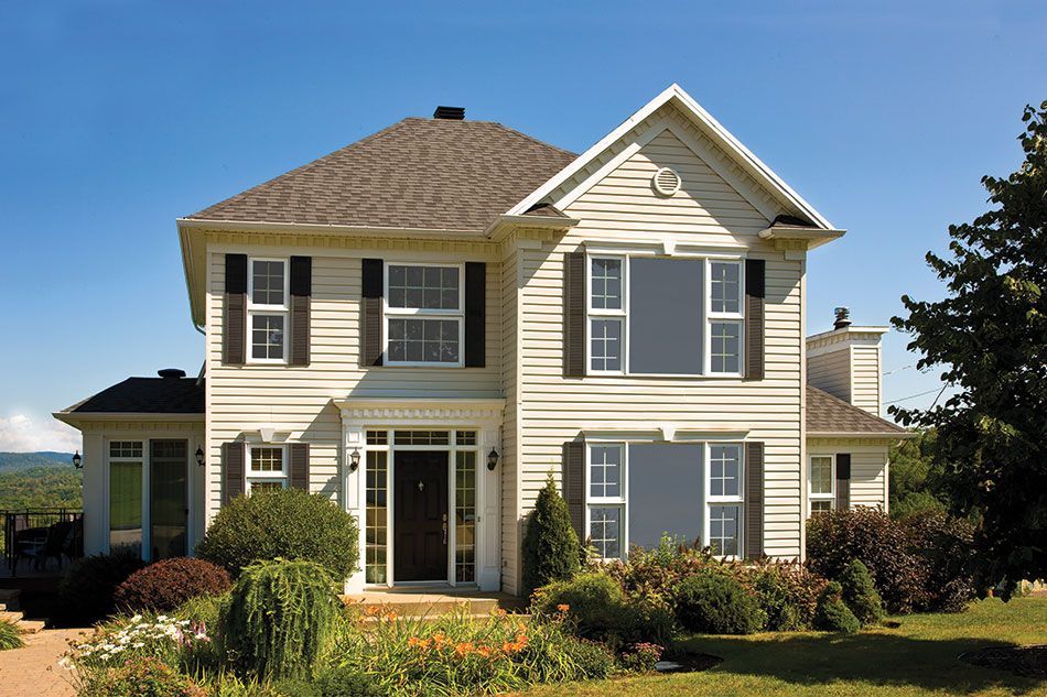 a large white house with black shutters on the windows