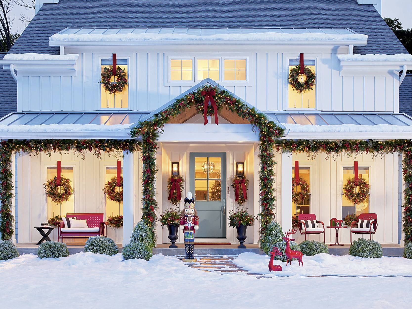 a white house decorated for christmas with a nutcracker in front of the door 