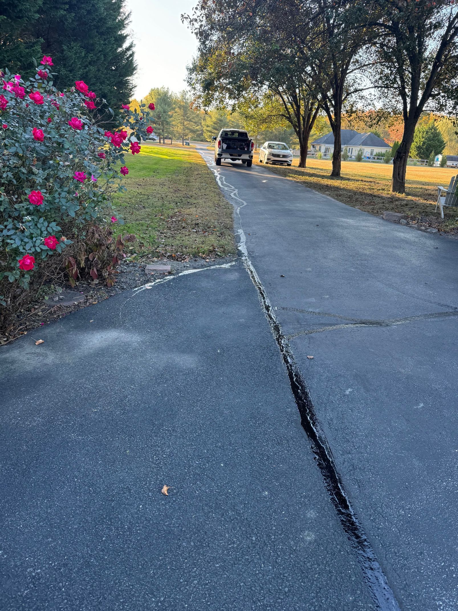 A Jeep Is Parked on The Side of A Road Next to A Driveway.
