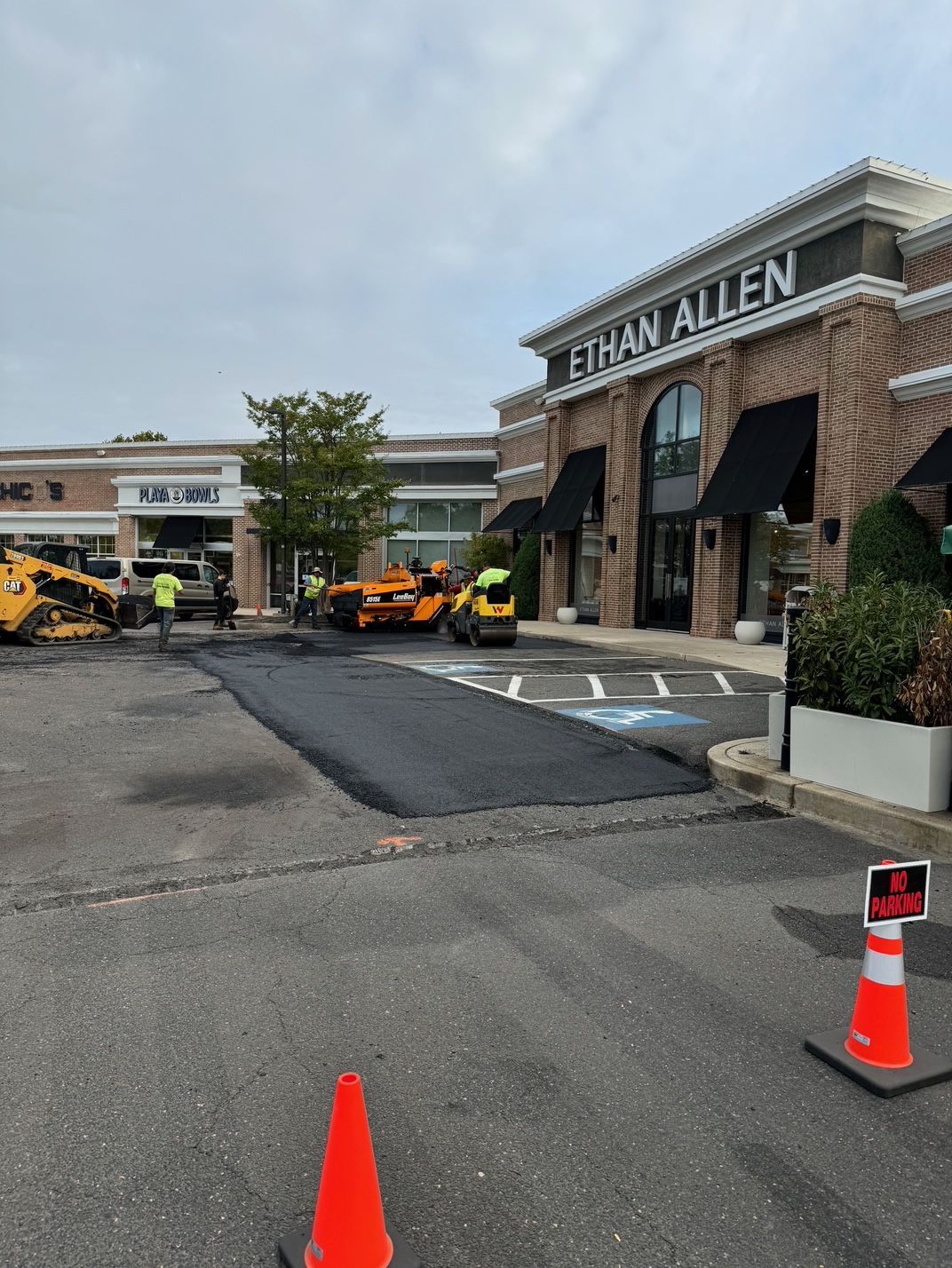A Parking Lot in Front of A Building that Says Ethan Allen