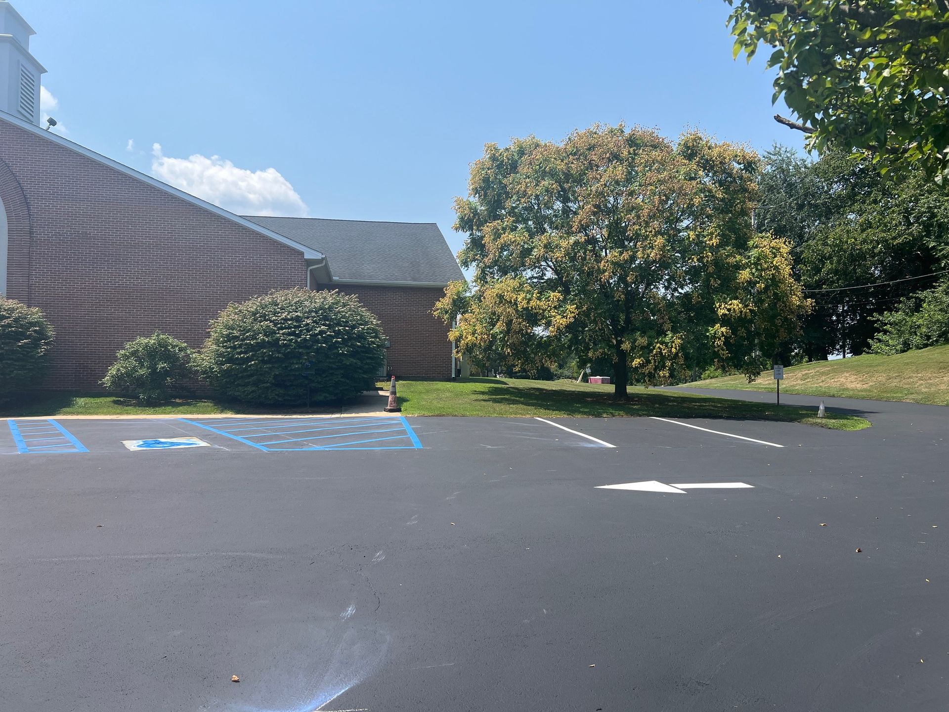 A Parking Lot with A Handicapped Parking Spot in Front of A Church.