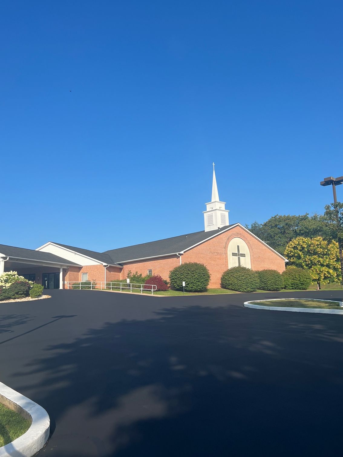 A Church with A Steeple and A Cross on The Front of It