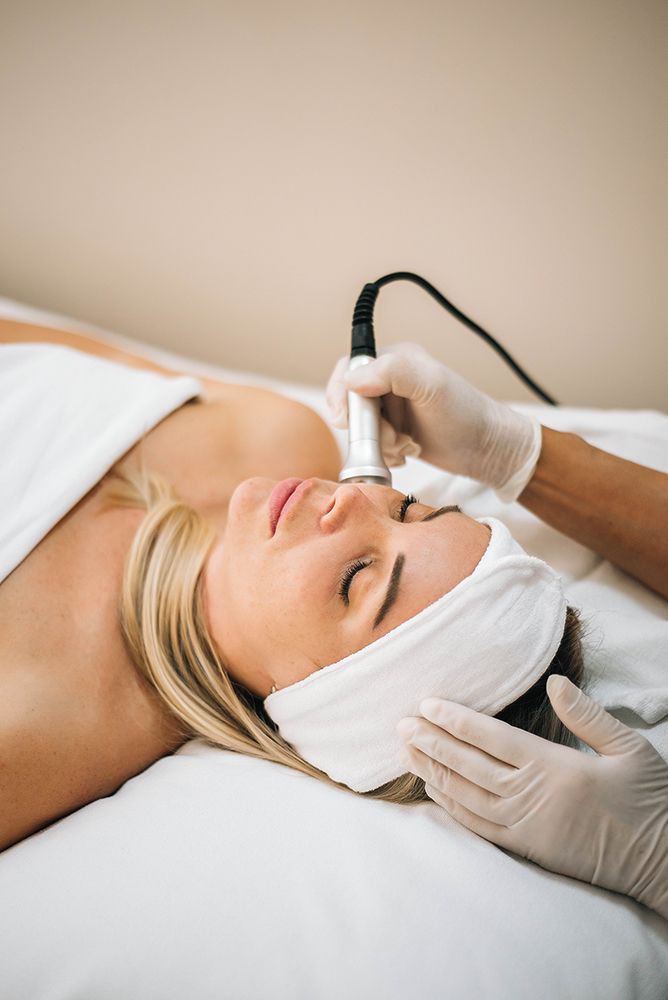 A woman is getting a facial treatment at a spa.
