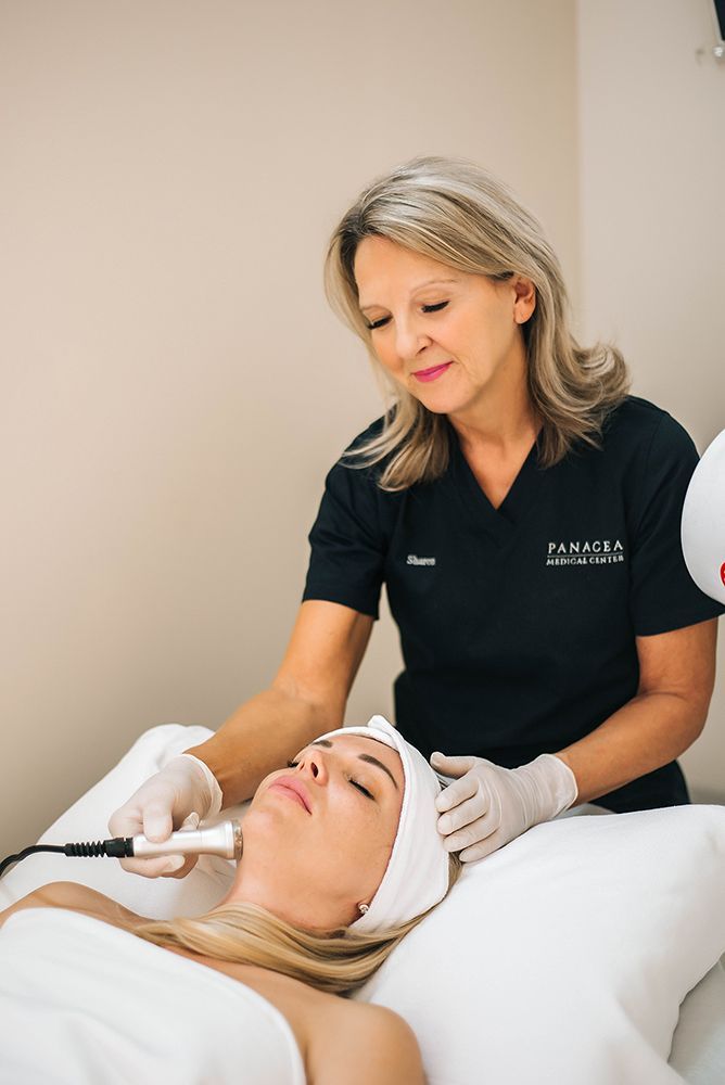 A woman is getting a facial treatment at a beauty salon.