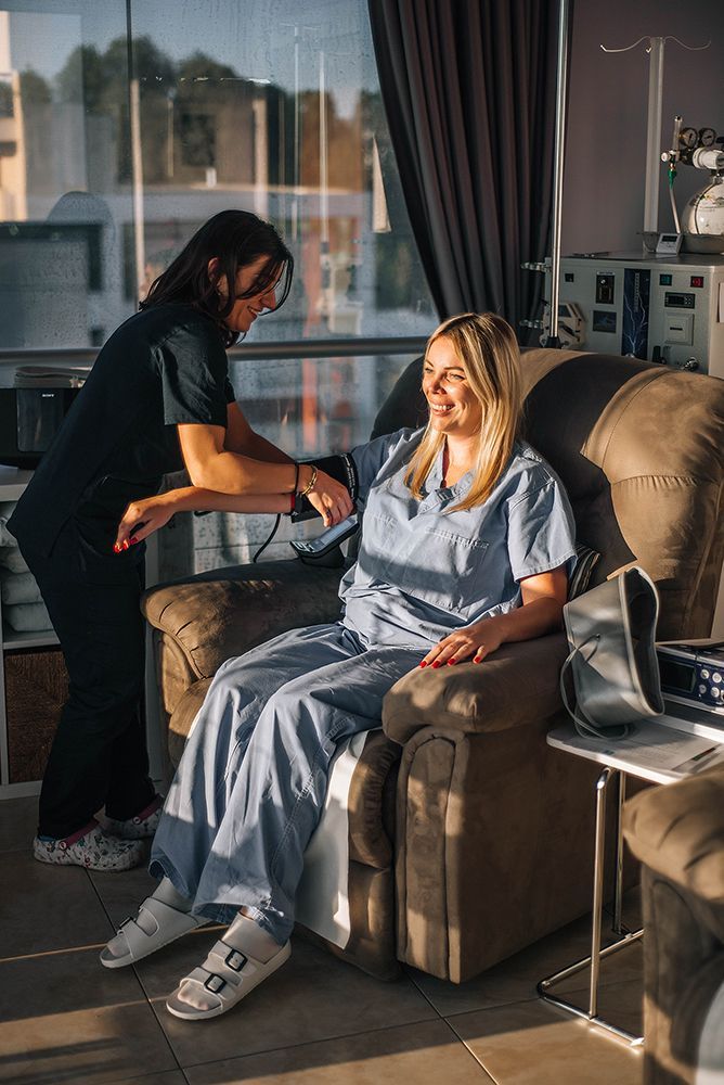 A woman is working on a machine in a room.