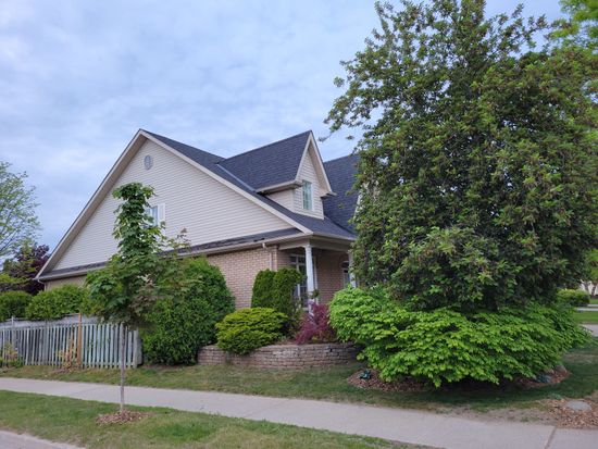 A house with a large tree in front of it