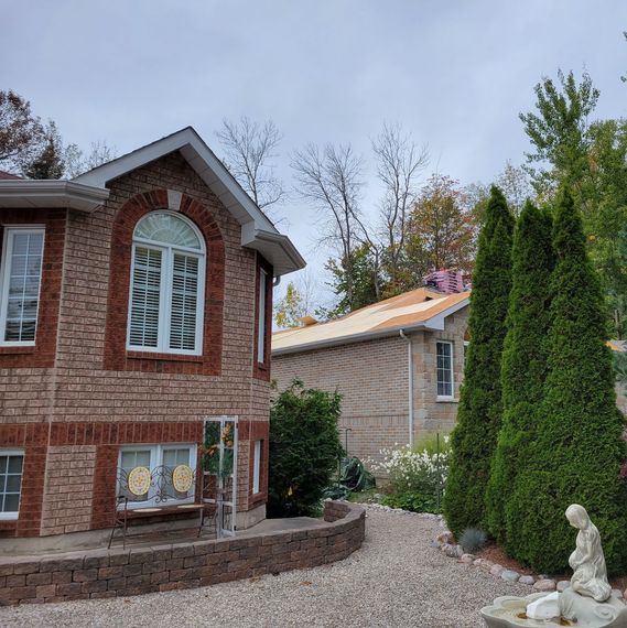 A brick house with a statue in front of it