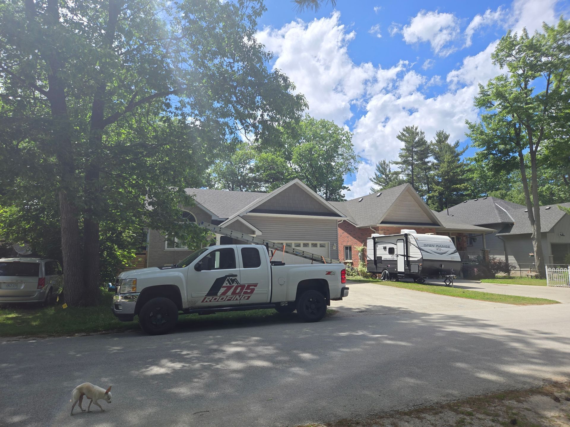 Two men wearing hard hats are working on a roof