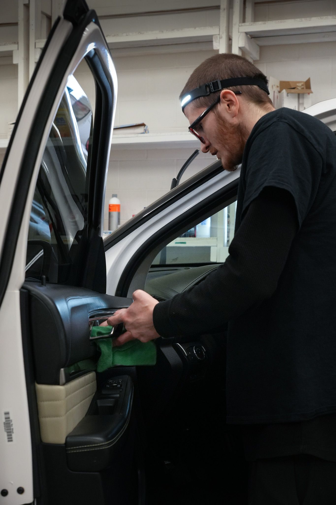 A man is working on a car in a garage.
