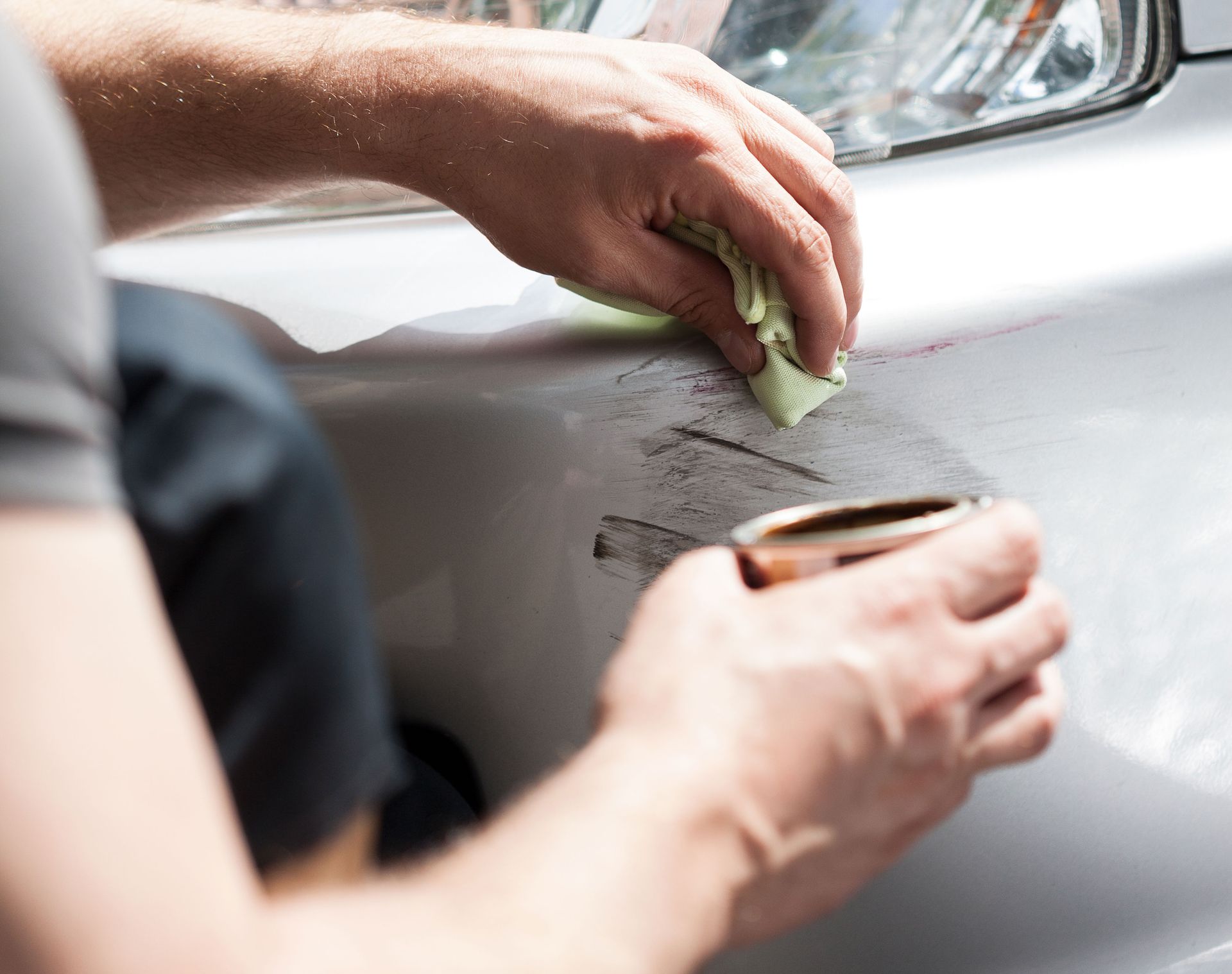 Man removing scratches from car