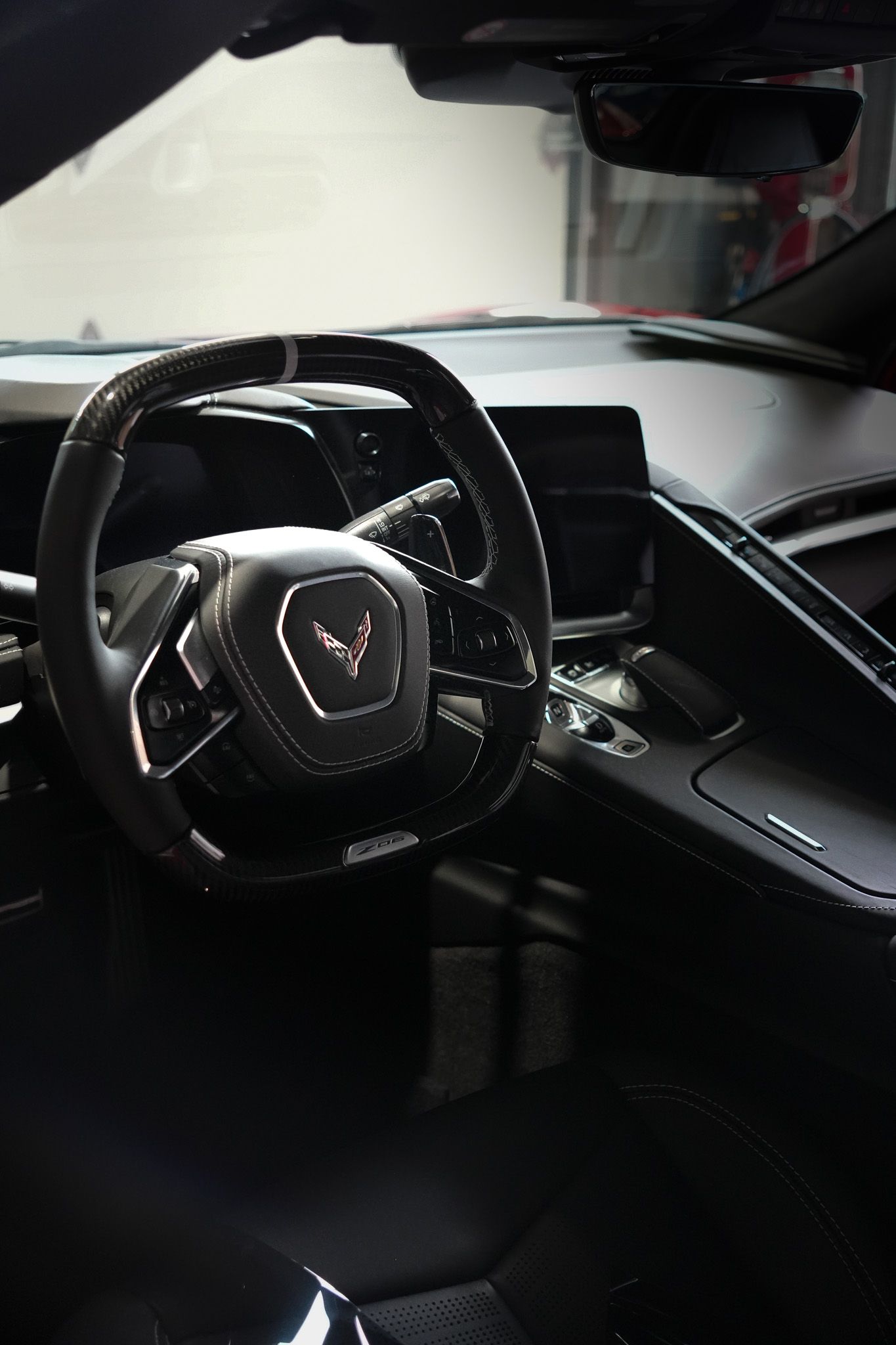 A close up of the steering wheel and dashboard of a car.