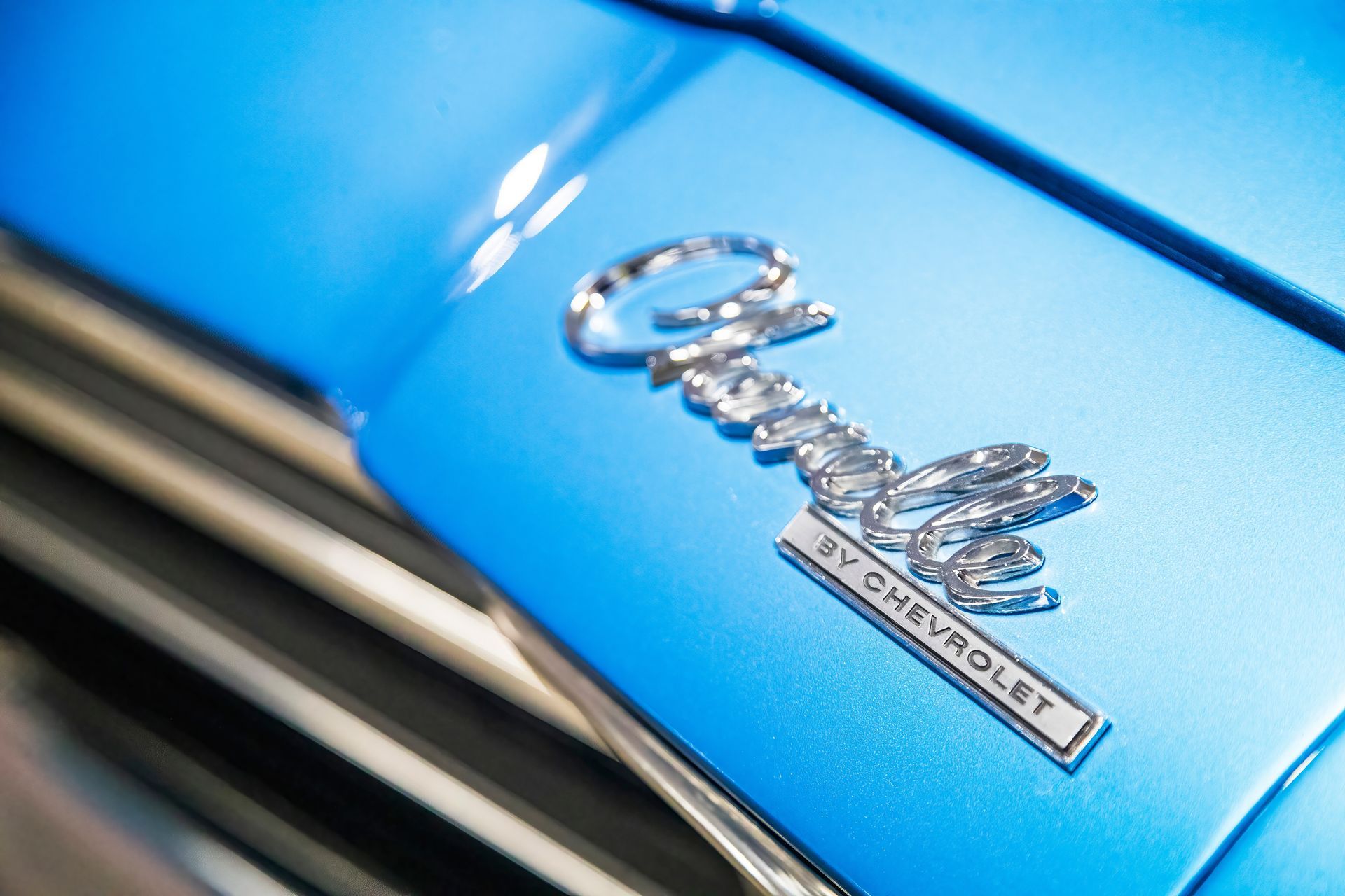 A close up of the hood of a blue chevrolet car