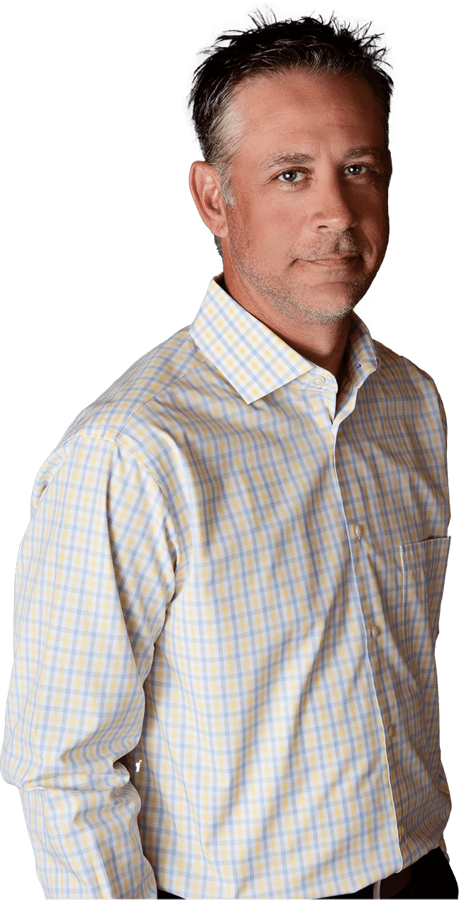 Man with short, graying hair in a light-colored plaid shirt, looking directly at the viewer.