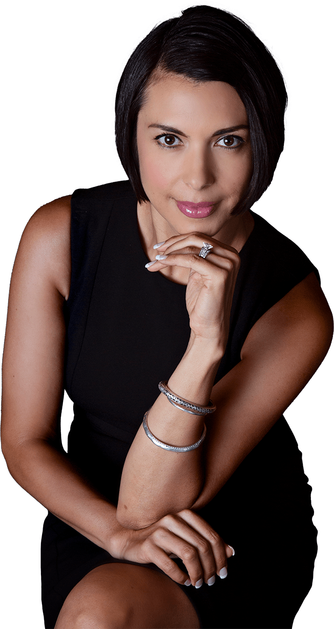 Woman with dark hair, in a black dress, resting her chin on her hand, looking at the camera.