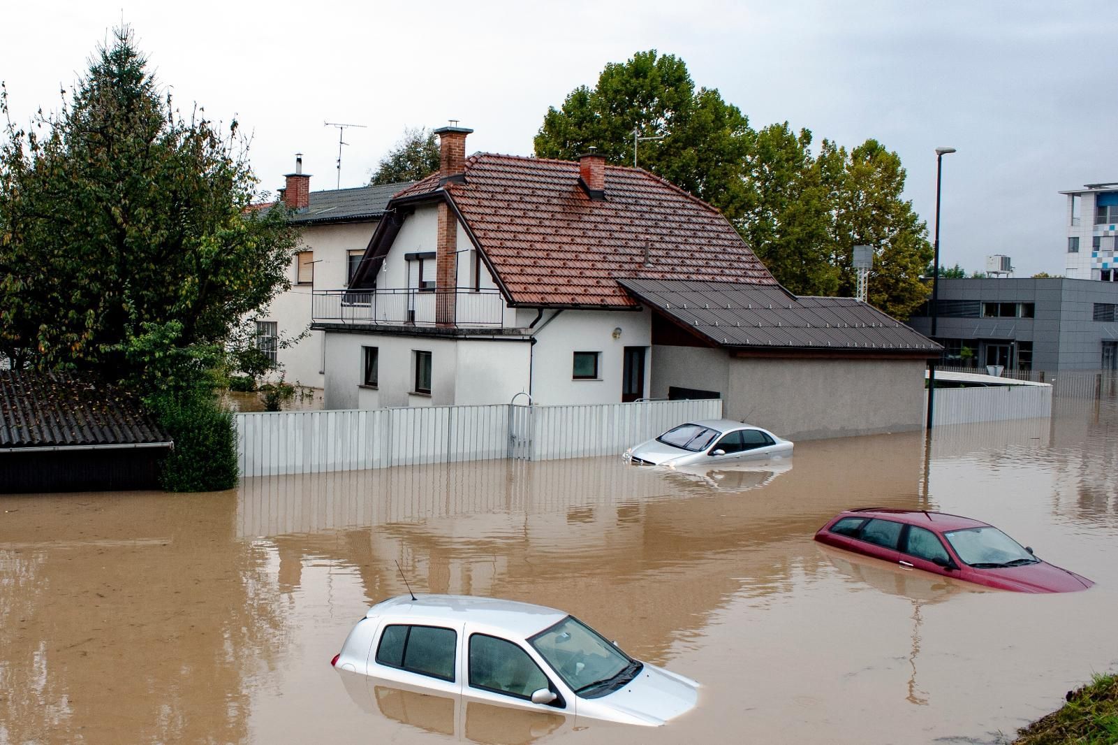 Houses and cars submerged in floodwater. 