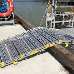 A metal ramp is attached to the side of a boat