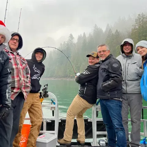 A group of people are posing for a picture on a boat.