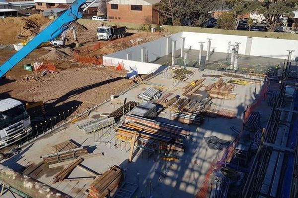 An aerial view of a construction site with a truck and a crane.