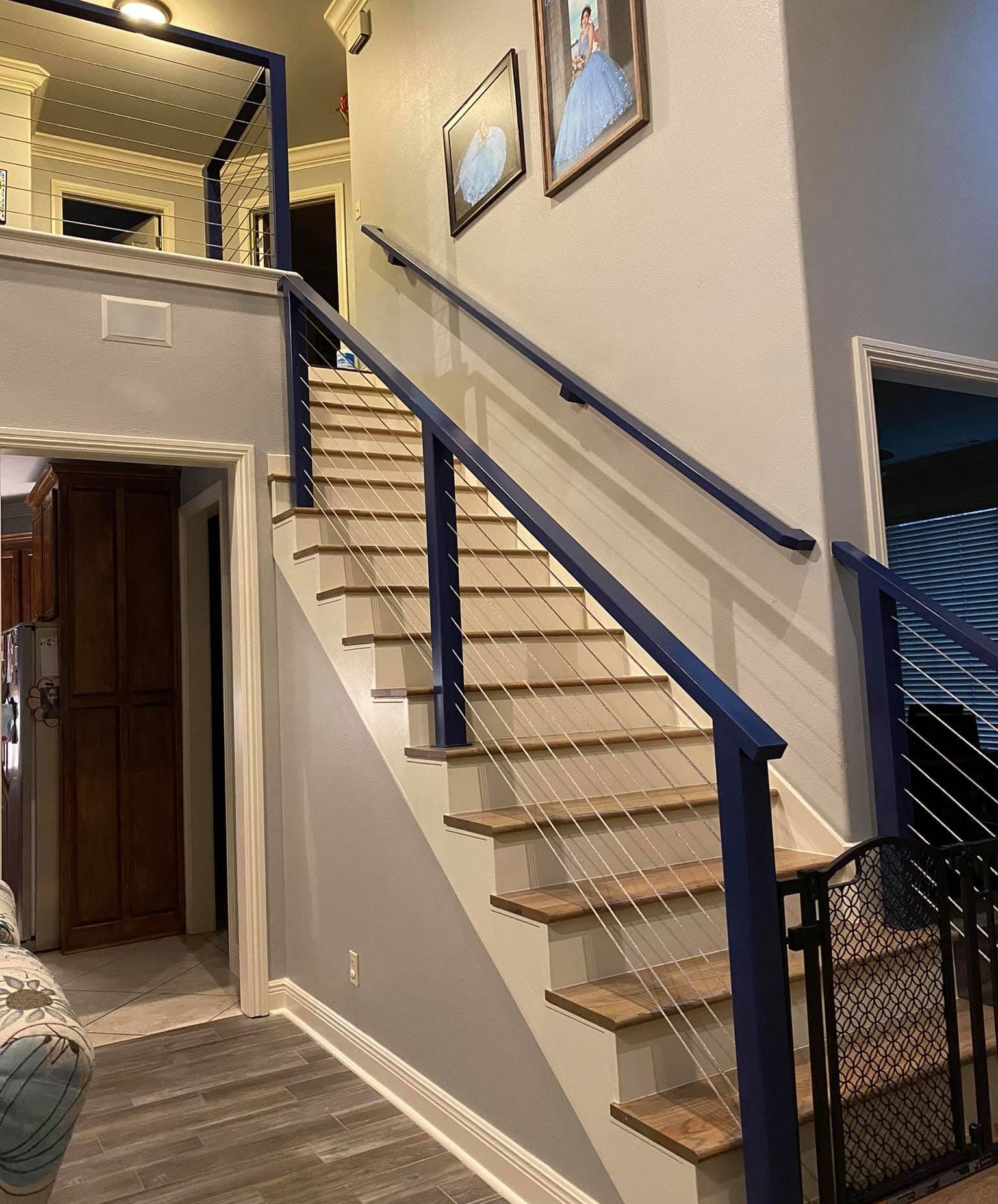 A staircase in a house with a blue railing