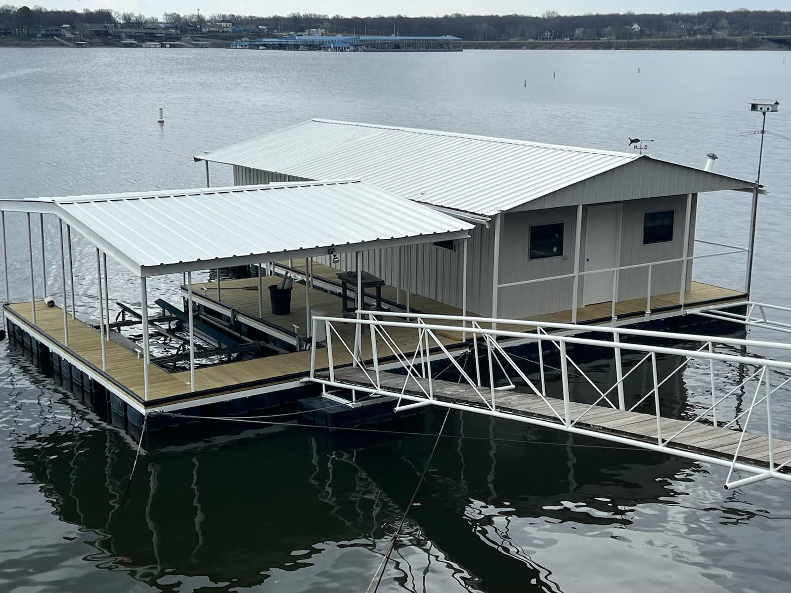 A floating house on a lake with a dock attached to it