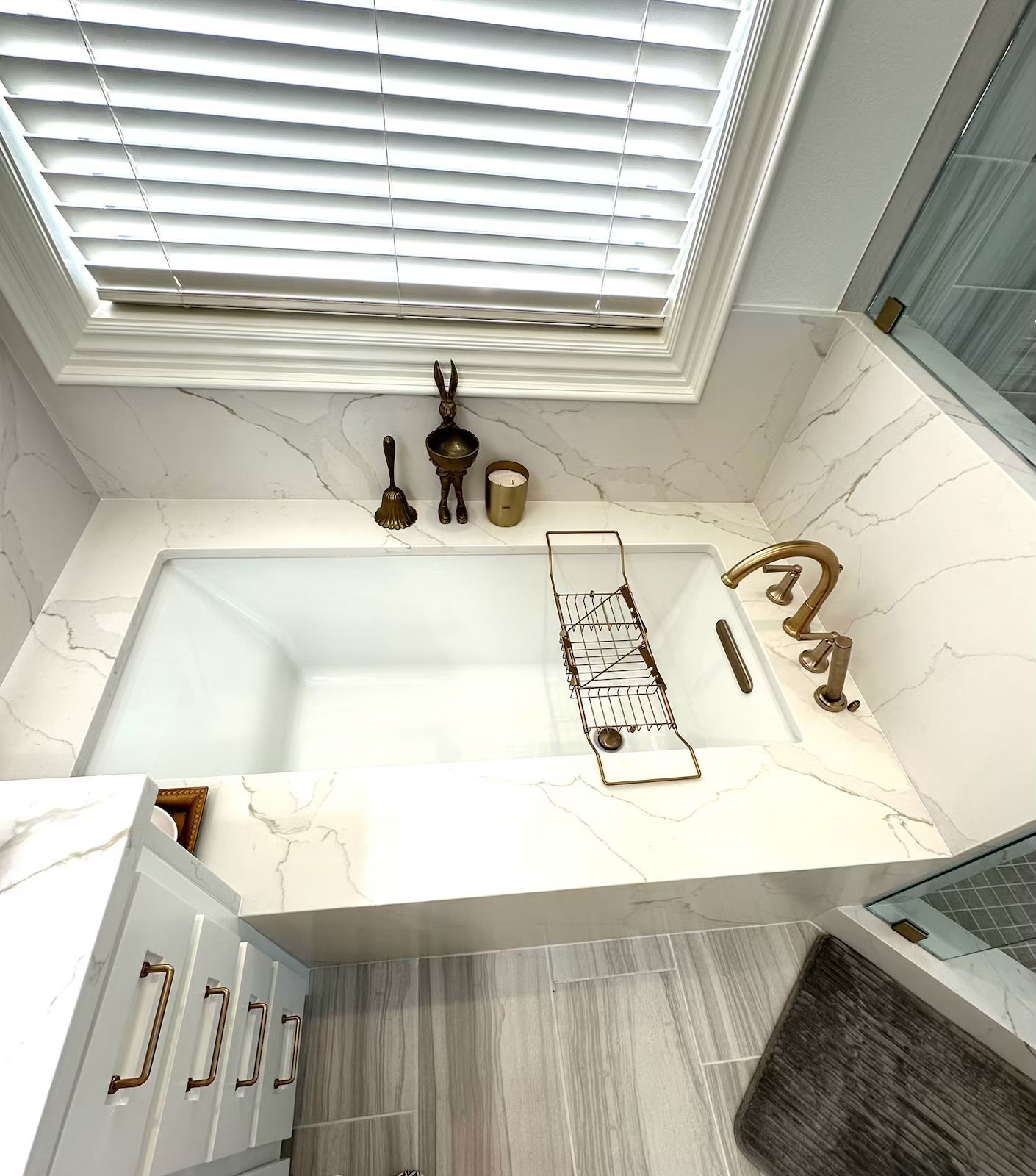 An aerial view of a bathroom with a bathtub and a window.