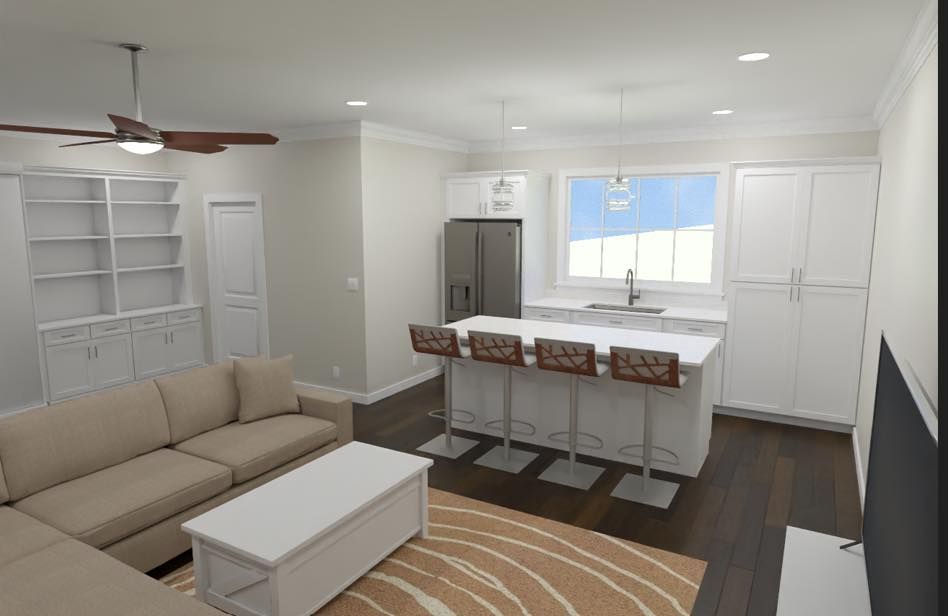 A living room with a couch , coffee table , and ceiling fan.
